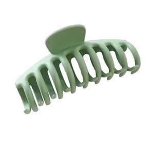 Matte light green plastic shark hair claw clip for women on white background