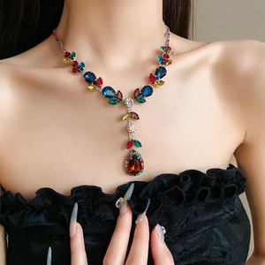 Detailed close-up of a leaf and teardrop zircon necklace with colorful gemstones