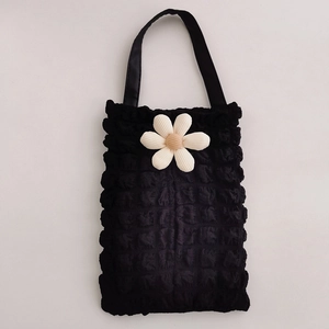 Detail of black bubble texture car tissue holder with 3D floral decoration