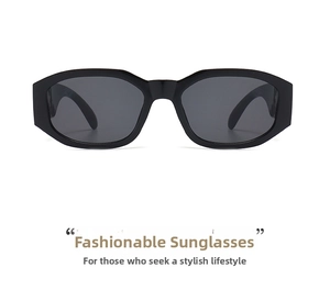 Close-up of black thick frame sunglasses with dark grey polarized lenses on white background