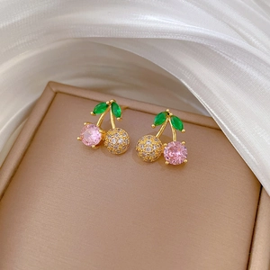Detailed close-up of cherry stud earrings with pink stones and green crystal leaves