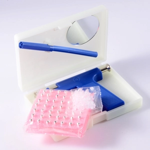 Professional blue ear piercing gun kit with 49 studs and marker in a compact storage box