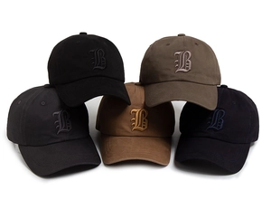 Detailed view of five cotton baseball caps featuring gothic letter B embroidery in various colors