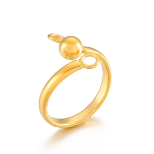 Detail of golden stainless steel ring with sphere and dual ring charm design