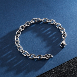Polished stainless steel hollow O-link bracelet with lobster clasp on dark background