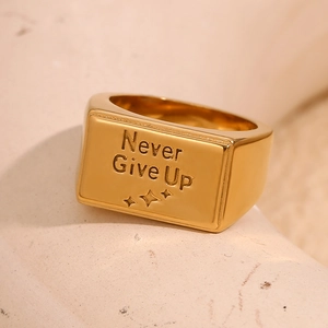 Detailed macro view of 18K gold plated square signet ring with Never Give Up engraving
