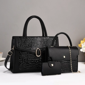 Three-piece black snakeskin pattern tote bag set with crossbody and clutch