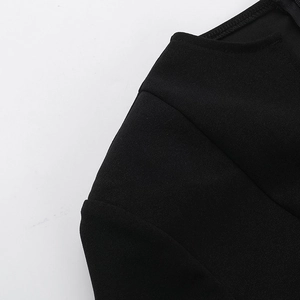 Detail of V-neck collar and shoulder stitching on black knit bodycon dress for women