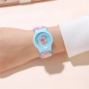 Close-up of child wrist wearing blue cartoon unicorn watch with soft silicone strap