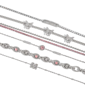 Titanium steel bracelet set with zircons featuring butterfly and pink stone charms