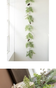 Detail of Christmas wreath featuring pine cones, white berries and antlers on green needles