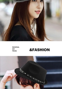 Detail of black wool fedora featuring silver punk studs and belt buckle trim for unisex