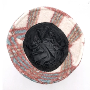 Detail of warm plush bucket hat featuring pink plaid pattern and quilted lining