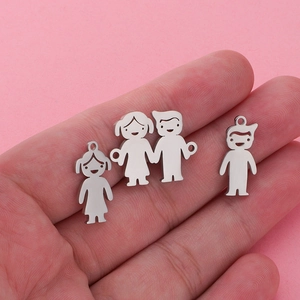 Close-up of three polished stainless steel pendants featuring boy and girl family shapes