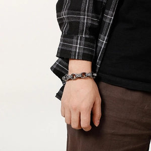 Close-up of vintage square Buddha head titanium steel bracelet worn on a wrist