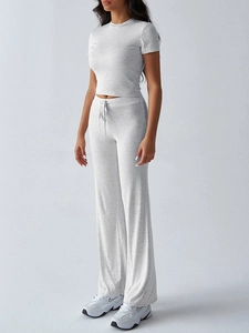Detail view of light grey short-sleeve top and drawstring pants set with mixed fabric texture