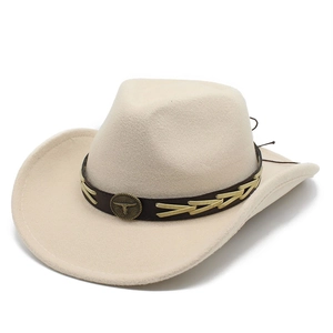 Detail of beige wool felt cowboy hat with brown band and bull head metal badge