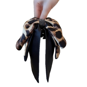 Leopard print bow hair claw clip with black satin ribbons and rhinestone detail
