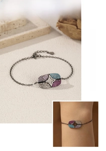 Detail of S925 silver black bracelet featuring colorful zircon stones and star cutout