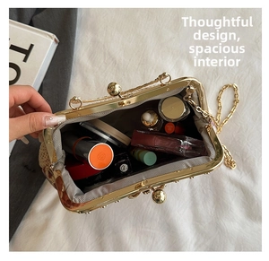 Detail view of woven evening clutch showing spacious interior with makeup and chain strap