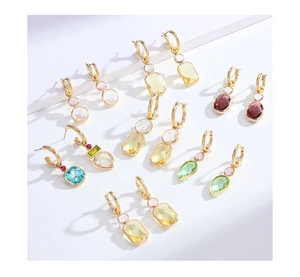 Detail of gold-plated hoop earrings with various colorful geometric crystal pendants