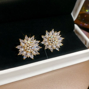 Close-up of 18k gold-plated sunflower stud earrings with pearls and marquise zircon stones