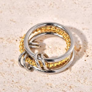 Detail of four-layer mixed metal ring featuring polished silver and gold beaded bands