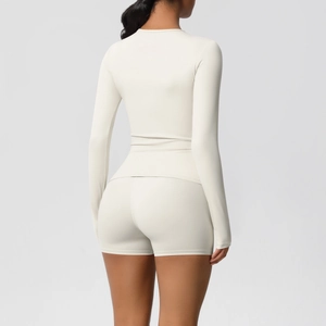 Rear view of off-white yoga set featuring a long-sleeve top and high-waist shorts