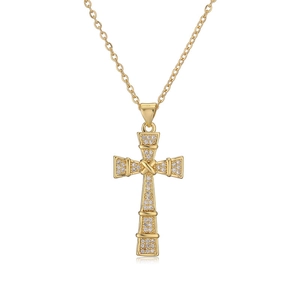 Close-up of golden cross pendant necklace with white cubic zirconia stones set in copper