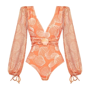 Detail of coral V-neck swimsuit featuring mesh long sleeves and white seashell patterns