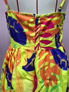 Detail of tropical leaf print and invisible back zipper on yellow maxi dress