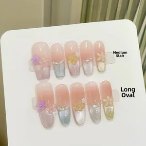 Detail of medium coffin and long oval press-on nails with 3D resin flowers and pearls