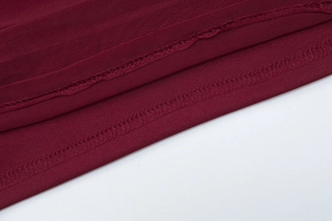 Détail de maille rouge vin et jersey montrant des finitions de couture de haute qualité