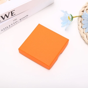 Detailed view of square orange jewelry gift box with textured finish and side opening