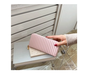Detailed shot of pink faux leather long purse with vertical quilting and gold zipper
