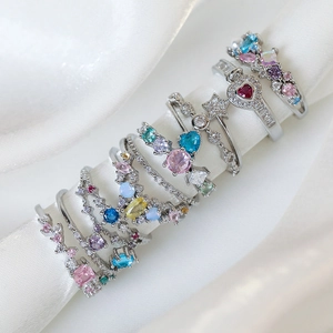 Minimalist silver rings with colorful heart and star zircon stones on white silk