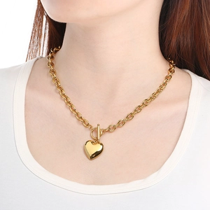 Gold stainless steel heart pendant necklace with chunky chain and OT clasp on model