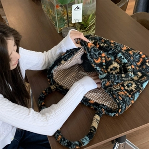 Detail view of the bohemian knit tote bag featuring a checkered lining and large capacity