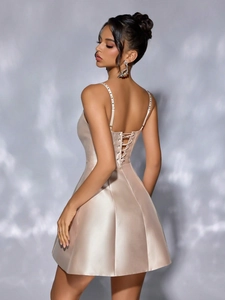Champagne satin mini dress with rhinestone straps and criss-cross back detail