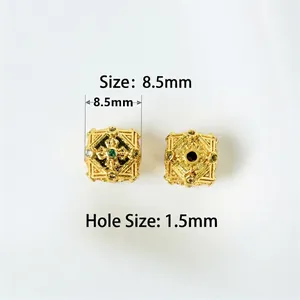 Macro view of 8.5mm gold hollow square beads with zircons and 1.5mm hole diameter