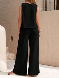 Back view of a black sleeveless top and wide-leg trousers set with crepe fabric texture