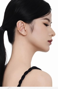 Close-up of gold minimalist and silver cubic zirconia ear cuffs on a model ear