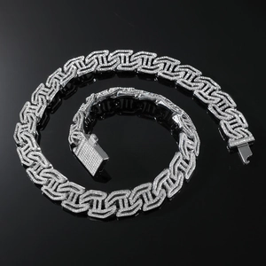 Macro view of silver Cuban chain with hollow H-pattern and shimmering cubic zirconia stones