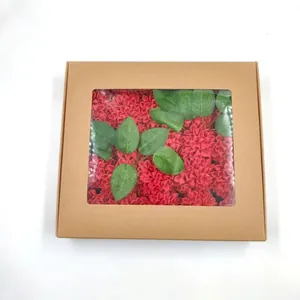 Brown kraft gift box with clear PVC window featuring artificial red flowers and green leaves