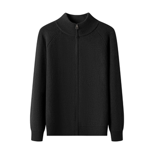 Close-up of black knitted cardigan featuring a high-neck zipper and dense texture