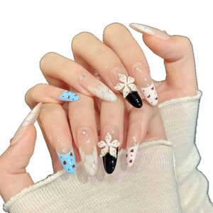 Blue and pink press-on nails with 3D floral accents and heart charms on long almond shape