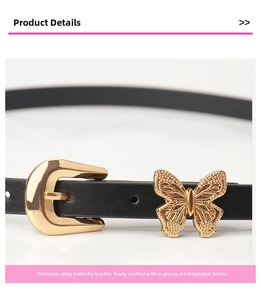 Detail of black slim leather belt with golden horseshoe buckle and butterfly ornament