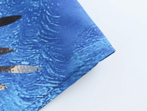 Detail shot of the stitching and woven fabric texture on a blue floral printed skirt