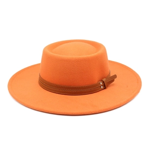 Detail view of orange wool fedora with brown faux leather double belt and metal buckle