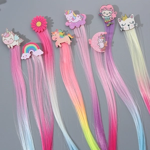 Detail of colorful hair extensions for kids with glitter unicorn and rainbow clips
